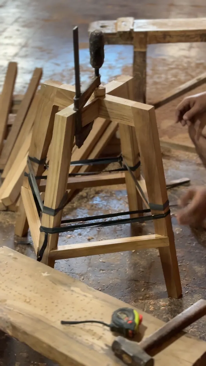 A stool frame strapped tight during assembly