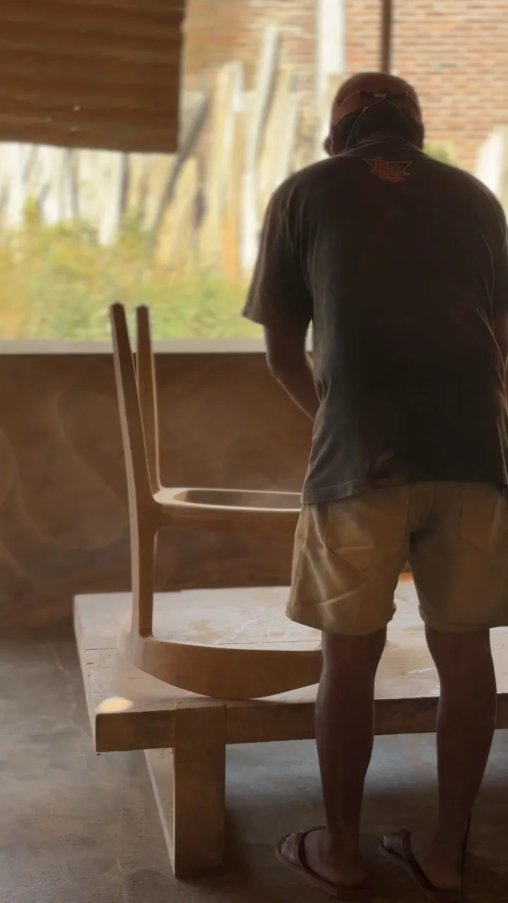 Smoothing a chair at the bench