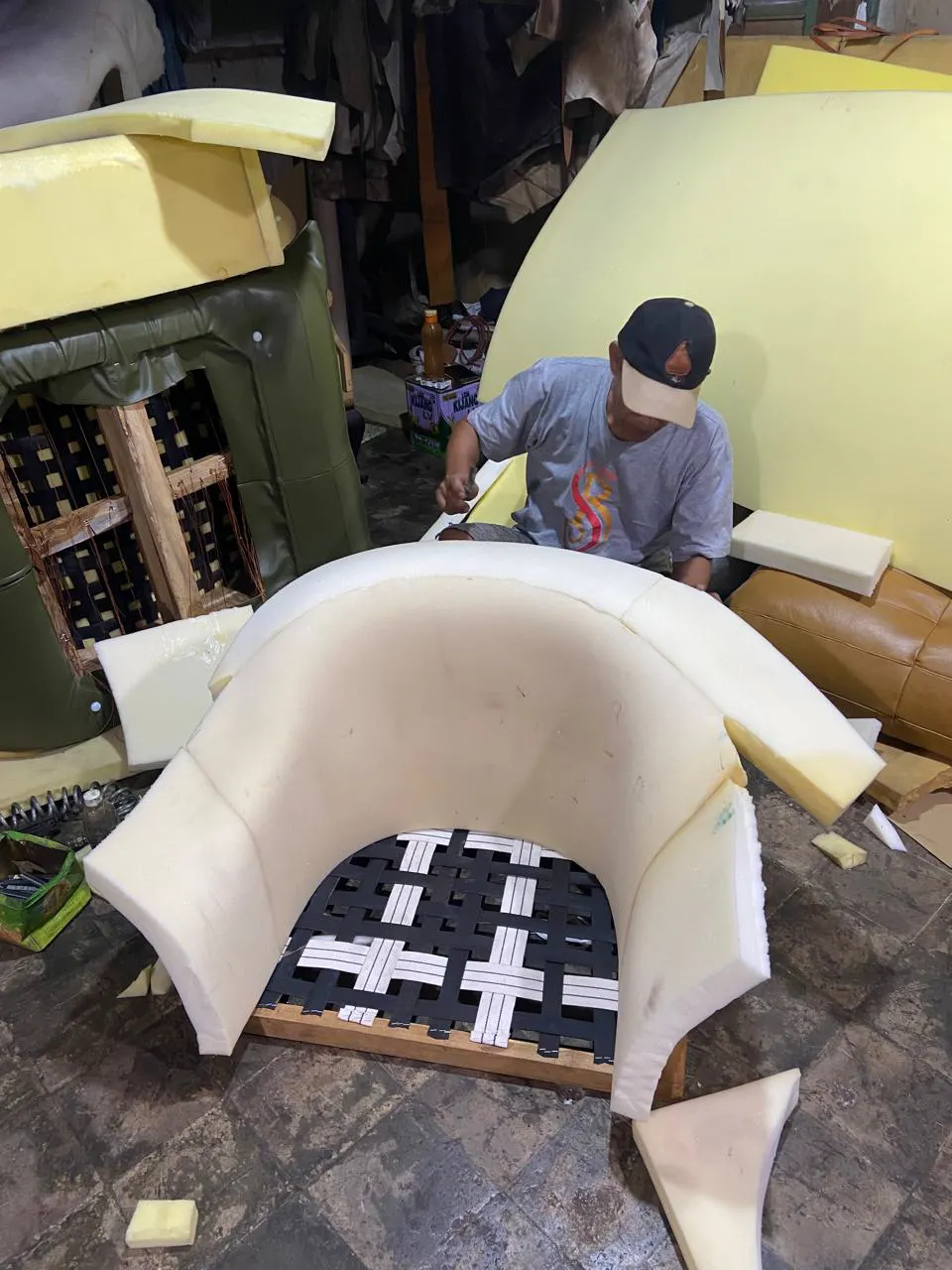 Foam shaped over a webbed armchair frame