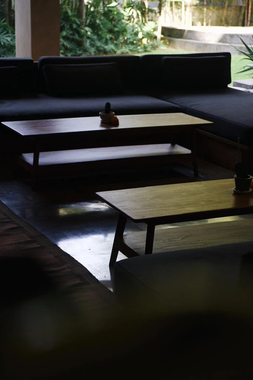 Custom teak seating with bold indigo upholstery in boutique hotel common area, Bali